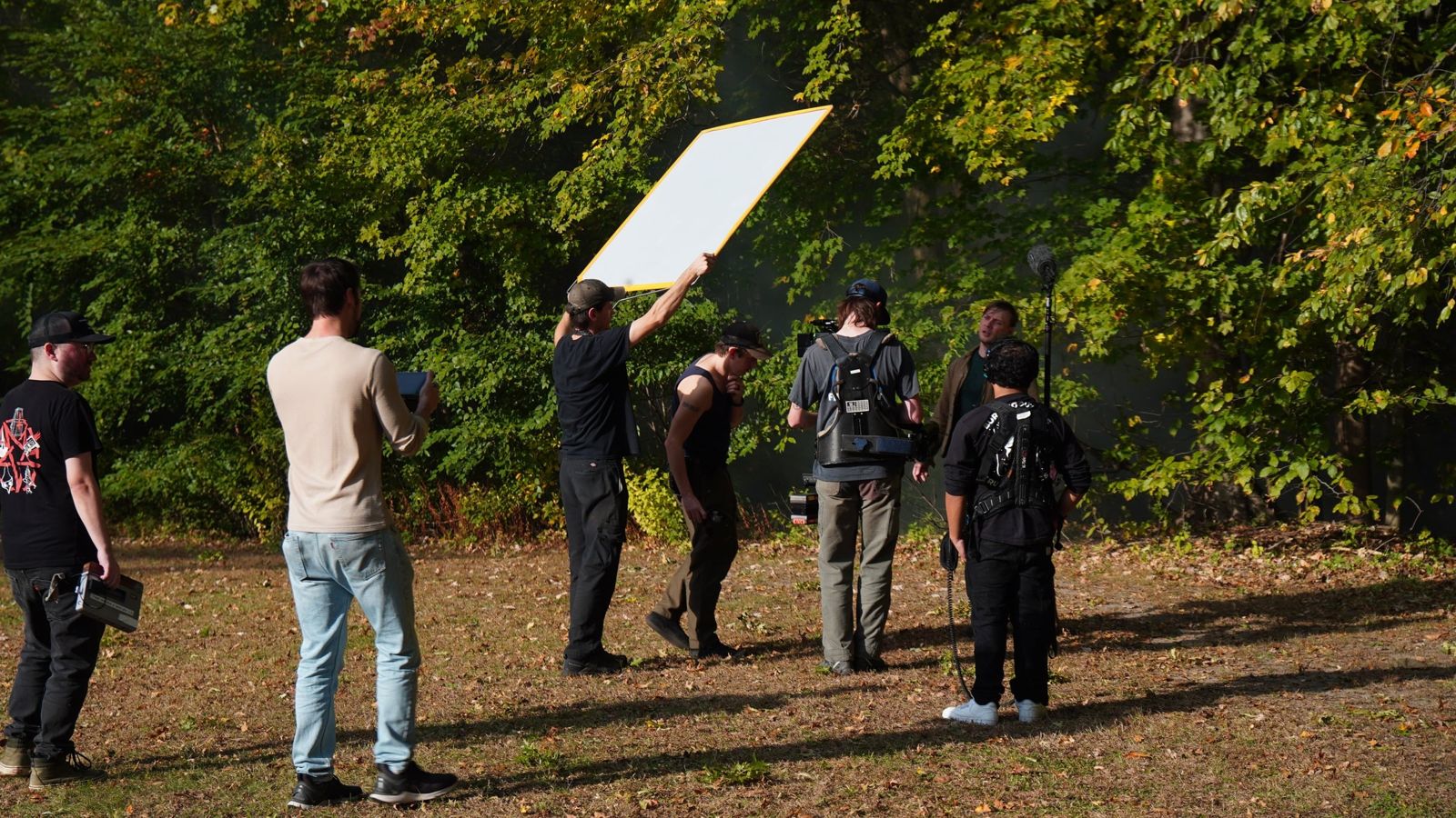 Grip crew holding a bounce board outdoors