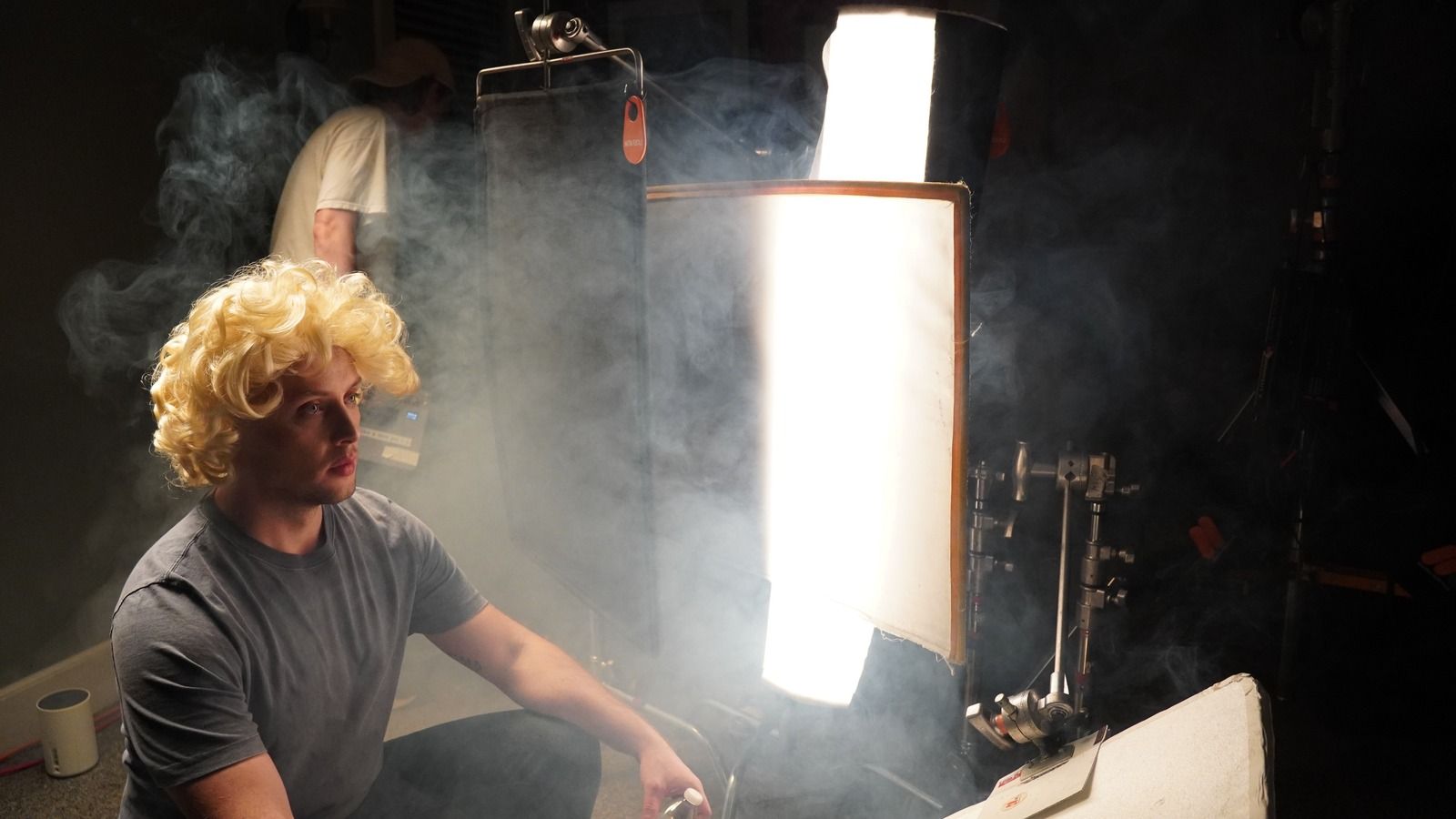 Actor lit by a hard side light through haze