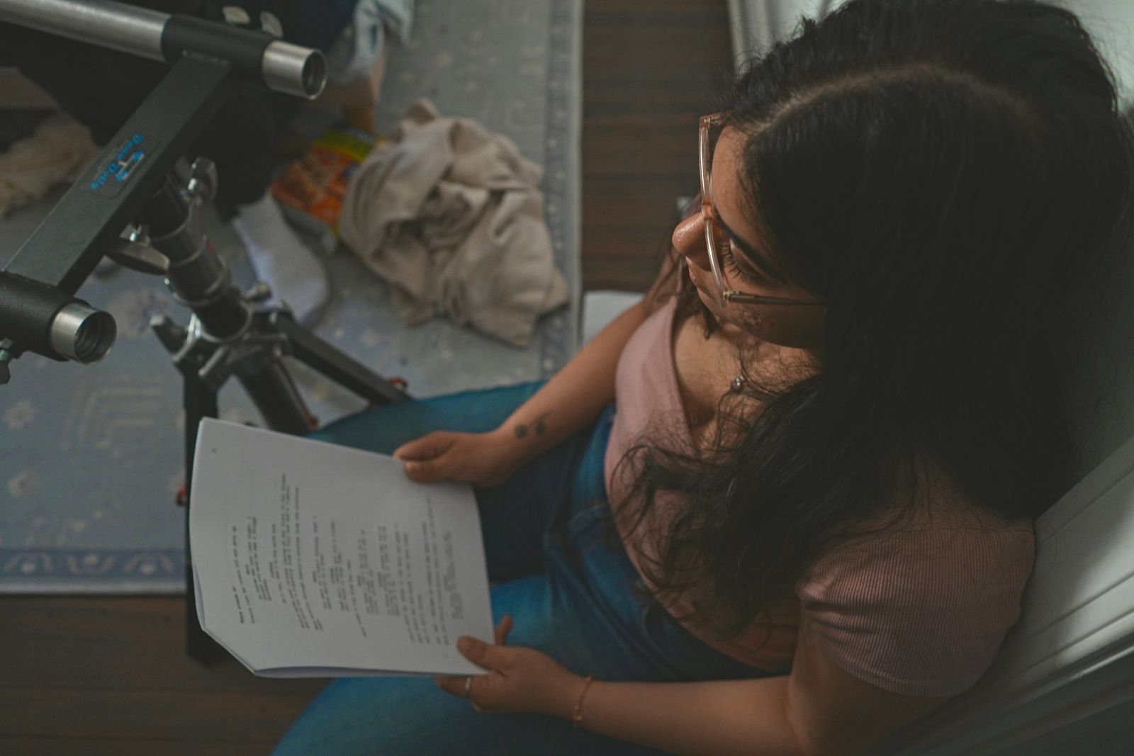 Script supervisor reviewing script pages on set